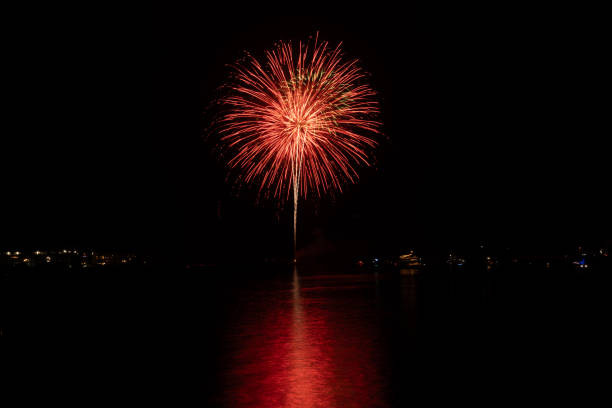 New Year's Eve fireworks over the channel in Marina del Rey, CA celebrate east coast midnight.