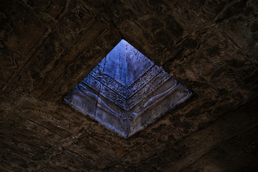 Qena, Egypt - December 27 2023: A skylight in the roof of Hathor temple at Dendera, Pyramid shape illusion