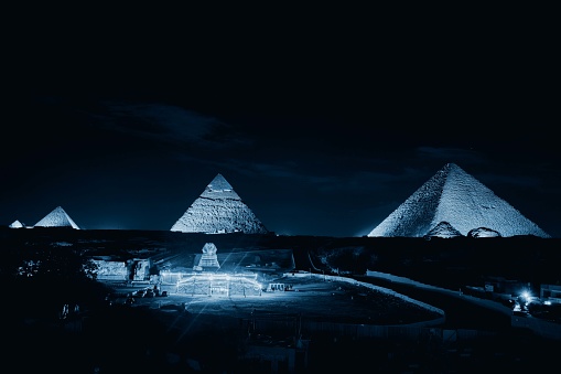 Giza, Egypt - December 24 2023: The Pyramids and the Sphinx in the night lights