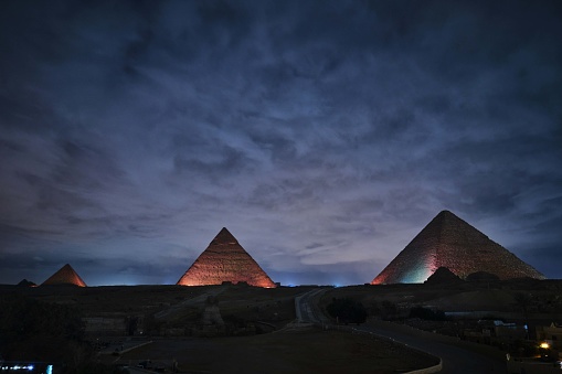 Giza, Egypt - December 24 2023: The Pyramids and the Sphinx in the night lights