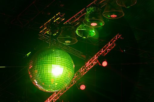 Large disco ball with stage lighting at an outdoor party