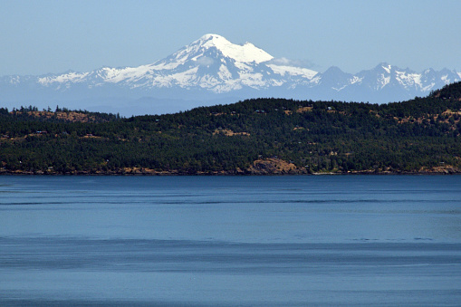 Photograph of Mount Baker taken from the top of Mount Douglas, on Vancouver Island, B.C. Canada. Taken at 11:52 on the 5th June 2023.

Mount Baker (Nooksack: Kweq' Smánit; Lushootseed: təqʷubəʔ), also known as Koma Kulshan or simply Kulshan, is a 10,781 ft (3,286 m) active glacier-covered andesitic stratovolcano in the Cascade Volcanic Arc and the North Cascades of Washington in the United States.