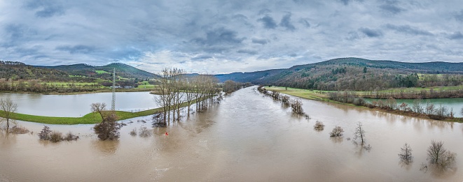 Drone image of the German river Main during a flood with flooded trees on the banks during the day