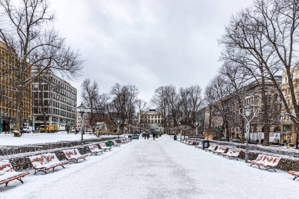 Helsinki, Finland. December 28th, 2023. One of the central parks of Helsinki covered with snow and some tourists.