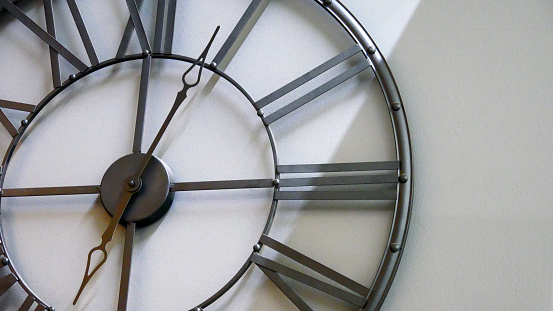 A beautiful frame clock hanging on the wall close-up