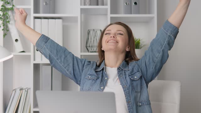 A woman wins the lottery. Winning an online game. Successful completion of the project. Joyful emotional reaction. Great news. An employee expresses his joy and extreme satisfaction in a home office