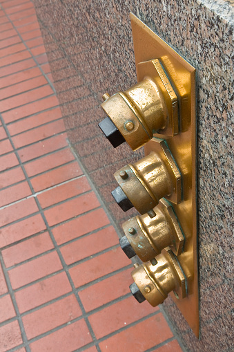 Auto sprinkler standpipe connector - Fire department connection outside of a building - Fire department connections for sprinkler systems and pump on the exterior wall in San Francisco