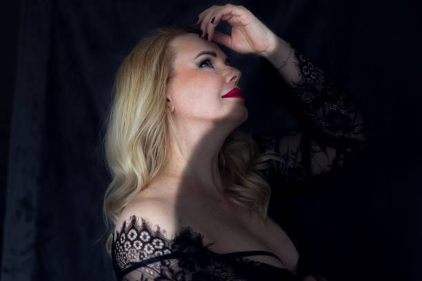 istock blonde in a lace black dress 1900123255