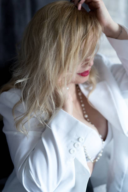 istock blonde girl in a white jacket with red lips 1900125313