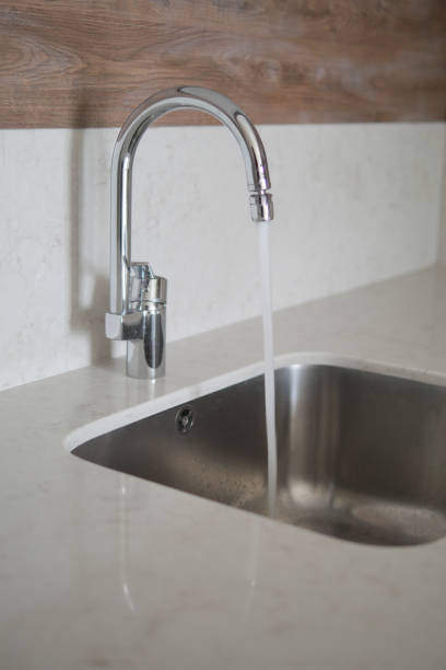 istock water pouring from a faucet tap slow motion 1900158419
