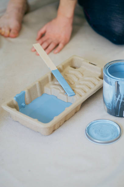 istock Open paint bucket, and paint in a painting tray 1900179430