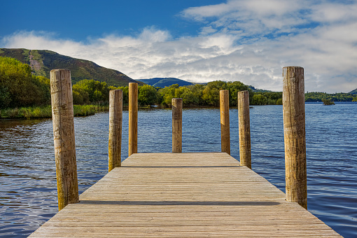 View of Derwent Water in the Lake District of Cumbria, England from a wooden jetty.