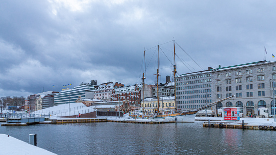 Helsinki, Finland. December 28th, 2023. The port by the market square of Helsinki in the Baltic sea during the winter. A sailing ship and the Etelänranta neighborhood.
