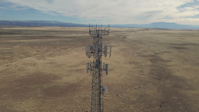 Closeup aerial view around of the telecommunications tower. On the top of a telecom tower installed antennas and transmitter wich transmits the signals of lte 5g 4g networks and mobile gsm operators.
