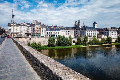 Orleans, France - August 10, 2023: City life in Orleans - view from the old bridge. Woman walking, cars.