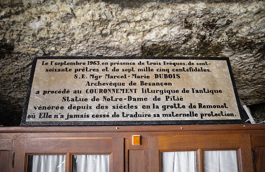 Combas, France - August 16, 2023: The Remonot cave-chapel of Our lady of Mercy, near the town of Combes in the French department of Doubs . French informations about the chapel.