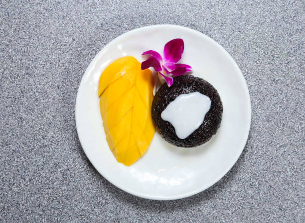 sticky rice with mango and coconut milk served in dish isolated on grey background top view of hong kong food