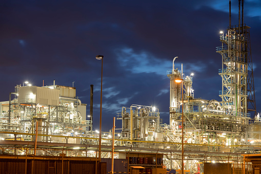 Modern petrochemical industry and oil refinery factory at dusk, Netherlands, Benelux, Europe.
