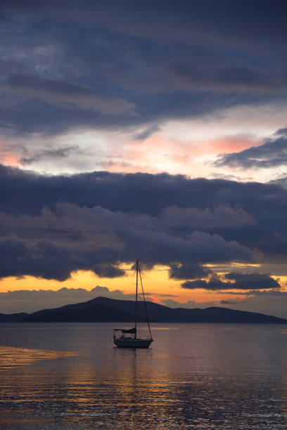 istock Alone sailboat at sunset. Atmospheric seascape with reflection 1900350811
