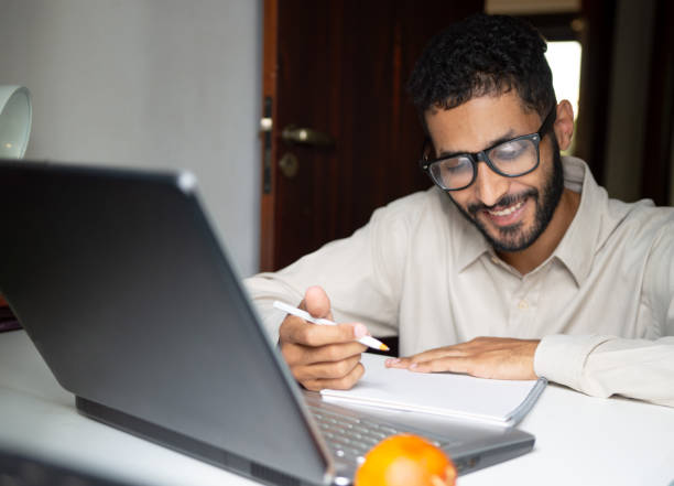 istock young black man studying for exams during the day at study table at home 1900387297