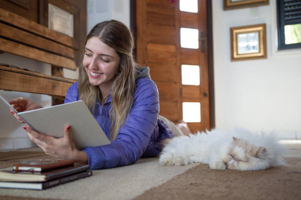 istock Beautiful young woman studying lying down for exams during the day 1900388334
