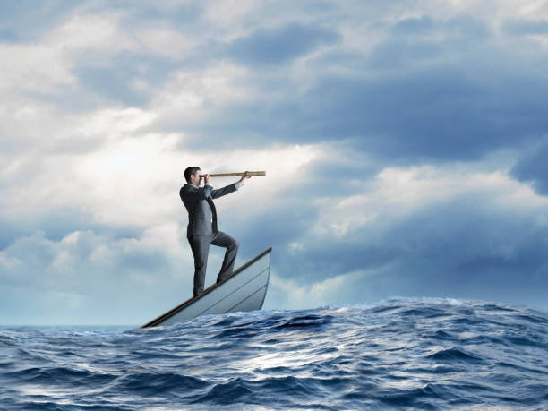 istock Stranded Businessman In Sinking Row Boat Searches For Help 1900389368