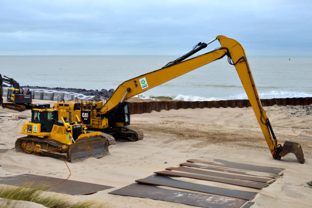 The machine drives wooden piles of groins to strengthen the sea coastline.