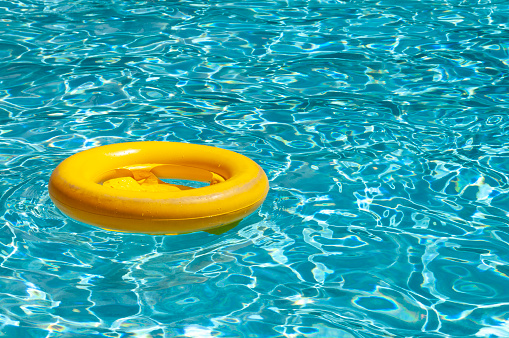 A child's floatation ring floating in a pool