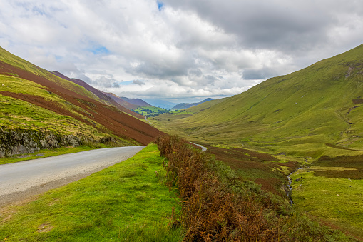 Winding mountain pass road in the Lake District of Cumbria, England.