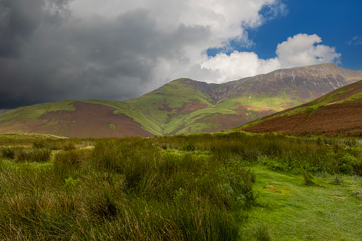 Dappled light falling on a mountain in the Lake District of Cumbria, England.