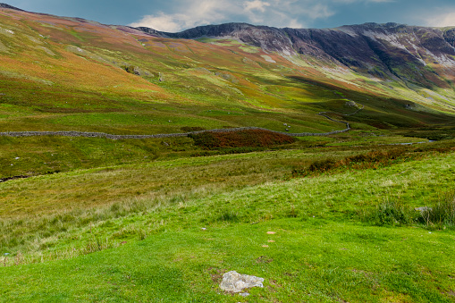 Dappled light falling on a mountain in the Lake District of Cumbria, England.