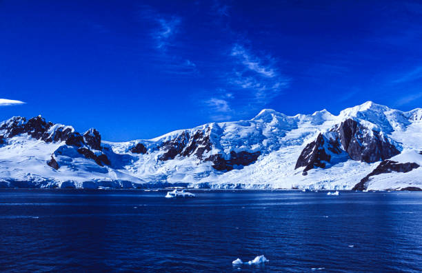 istock Snow Covered Mountains and Glaciers Formations in Antarctica bay. 1900610658