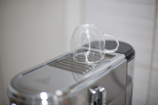 Coffee cup on coffee machine, heating up coffee cup
