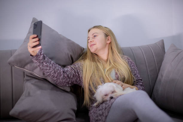 istock Young woman taking selfie with her dog 1900617828