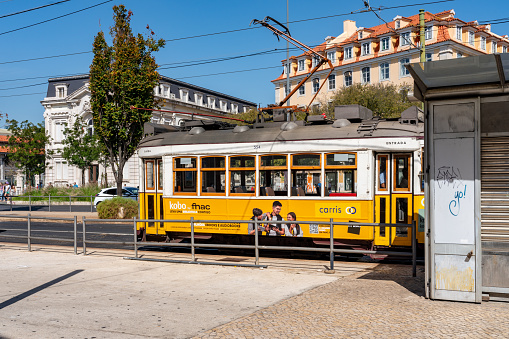 Lisbon, Portugal - Oct. 1,2023: The street view of Av. 24 de Julho, Tram and Cityscape around Time Out Market, Lisbon, Portugal.