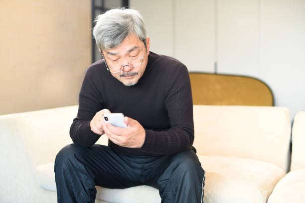 istock An elderly Asian man with white hair operating a smartphone 1900704802