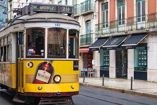 Porto, Portugal -April 1, 2018: Old town street view with yellow vintage tram