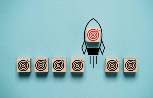 Red dartboard with arrow on rocket take off and move out from black dartboard for enhance and outstanding of business objective target goal concept.