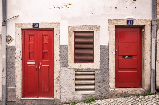 Red doors on a white wall, Bairro Alto, Lisbon, Portugal