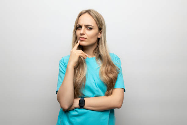 istock woman showing doubt and uncertainty on white background 1900750443