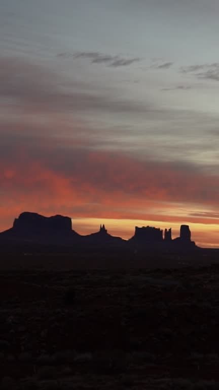 Vertical Video Monument Valley Tribal Park in Navajo Country Arizona and Utah, Buttes under Sunset Sky