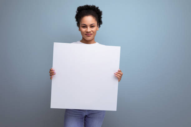 istock young hispanic brunette woman showing blank billboard mockup 1900756704