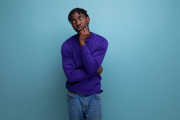 istock pensive dark-skinned african young man with dreadlocks in casual clothes 1900756757