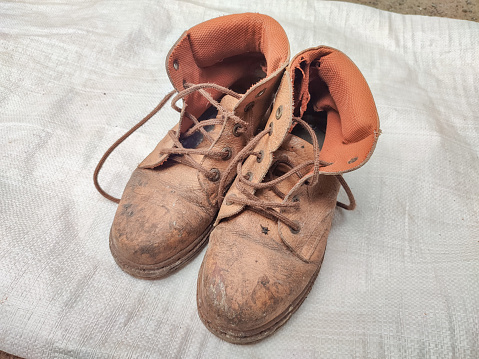 very dirty old and worn boots