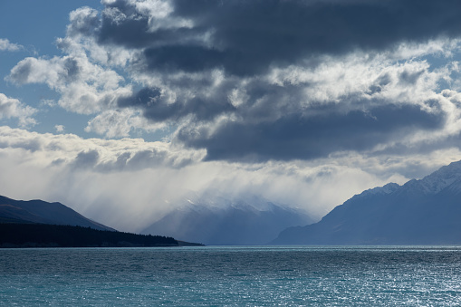 Looking north up Lake Pukaki you would normally see Mt Cook, New Zealand's highest mountain, but today a storm is raging. Although sunny at the southern end of the lake, streams of rain pour down at the northern end, hiding the mountains.