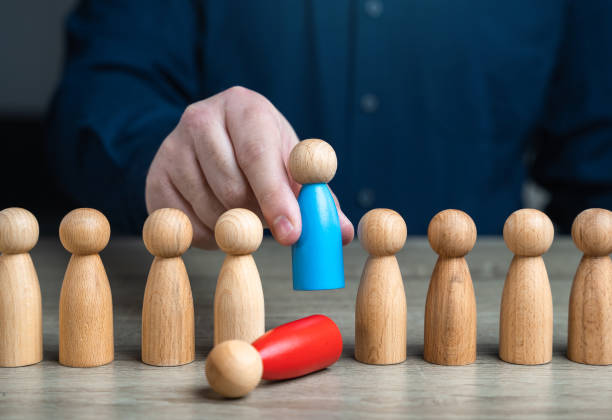 istock Replacing an old worker with a more loyal or productive one. Installing a subservient leader, easily influenced, and serves the interests of others. Human resources and HR policy. 1900824591