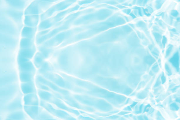 istock Bluewater waves on the surface ripples blurred. Defocus blurred transparent blue colored clear calm water surface texture with splash and bubbles. Water waves with shining pattern texture background. 1900836243