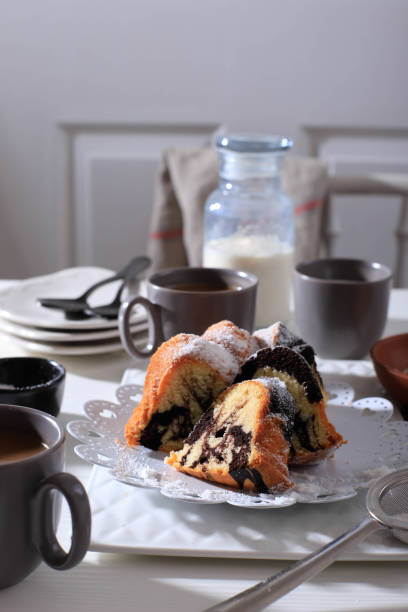 istock Marble Cake with Coffee with Powder Sugar and Kitchen Vintage Utensil, White Bakery Concept 1900921134