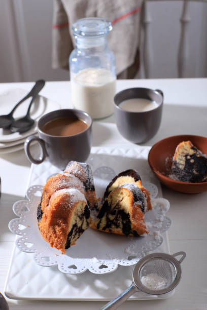 istock Marble Cake with Coffee with Powder Sugar and Kitchen Vintage Utensil, White Bakery Concept 1900921135