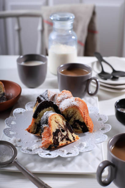 istock Marble Cake with Coffee with Powder Sugar and Kitchen Vintage Utensil, White Bakery Concept 1900923036